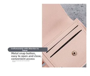 Detail of pink lychee leather card holder featuring a secure round metal snap button