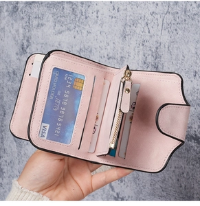 Pink matte leather wallet detail showing interior card slots and secure metal zipper