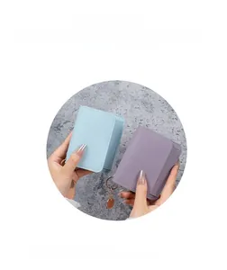 Close-up of litchi grain faux leather mini card holders in light blue and purple colors