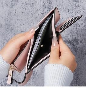 Detailed interior of a pink wallet showing card slots and a spacious bill compartment