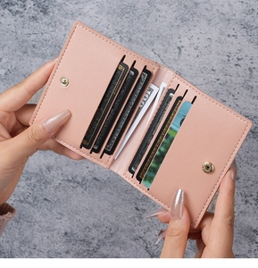 Interior detail of slim pink pebbled leather card holder with 8 card slots and snap