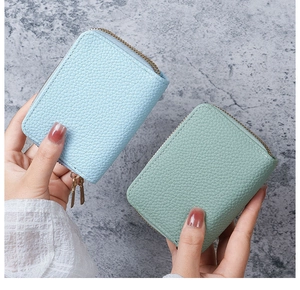 Detail of lychee pattern PU leather card holders in light blue and bean green