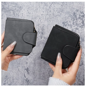 Close-up of minimalist grey and black matte wallets with stitching and U-buckle detail