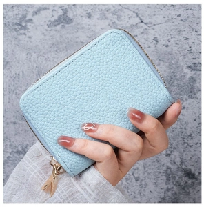Detail shot of light blue litchi pattern PU leather card holder with gold zipper