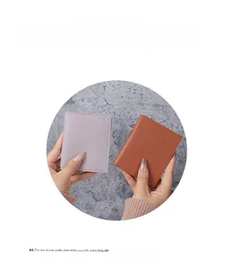 Close-up of compact leather card holders in purple and tan with precise stitching