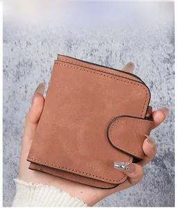 Detail view of a vintage brown matte PU leather short wallet with snap button closure