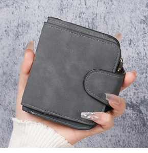 Detail of gray matte wallet with white stitching and snap closure for women