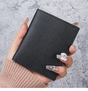 Close-up of slim black lychee grain leather card holder with neat edge stitching details