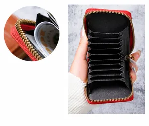 Detail view of red accordion wallet showing multiple card slots and gold hardware zipper