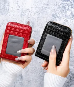 Close-up of red and black pebble leather card holders with zipper and ID window