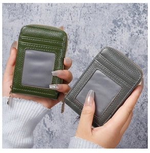 Detail of dark green and grey leather card holders with gold zippers and RFID blocking