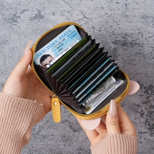 Yellow accordion card holder with cute pink ears and multiple slots for organization