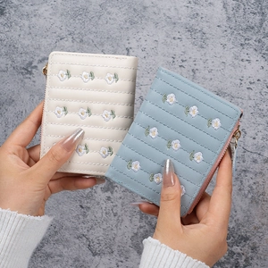 Fashionable embroidered short wallet in cream and blue with quilted floral patterns
