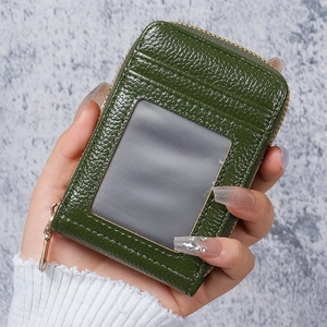 Close-up of compact dark green pebbled leather card holder with multi-slot design and zipper