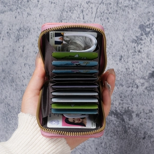 Pink leather accordion credit card wallet with gold zipper and anti-theft design