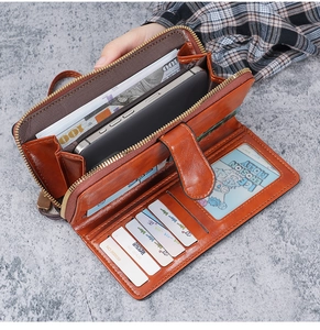 Interior detail of a brown PU leather wallet featuring multiple card slots and phone pocket