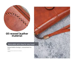 Detail of oil wax PU leather long wallet with laser-cut holes and removable wrist strap