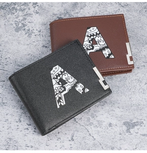 Detail of short bifold wallets in black and brown faux leather with graffiti A pattern