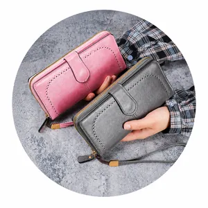 Detailed view of large capacity oil wax PU leather wallets in pink and gray with punch holes