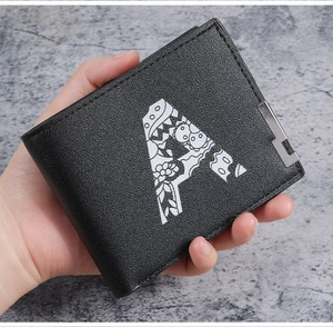 Close-up of black leather wallet with artistic floral letter A print and metal corner