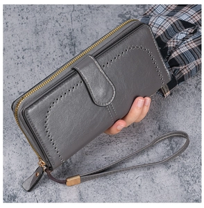 Close-up of oil-waxed PU leather wallet with lychee texture and circular punch detail