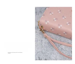 Detail of pink floral long wallet with quilted stitching and detachable wrist strap