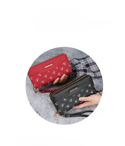 Detailed view of quilted long wallets with floral patterns in red and black colors