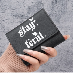 Close-up of black PU leather wallet with stay feral gothic text and bat pattern