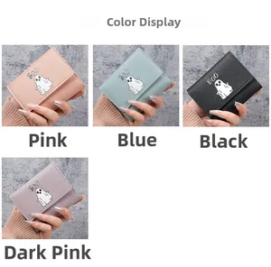 Detail view of multi-color cartoon ghost wallets in pink, blue, black, and deep pink