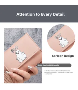Close-up of pink PU leather wallet with cute cartoon ghost pattern and fine texture