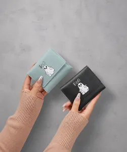 Close-up of minimalist tri-fold mini wallet with cute ghost print and BOO text detail