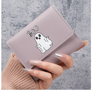 Close-up of lilac tri-fold leather wallet with a cute white ghost cartoon and BOO print