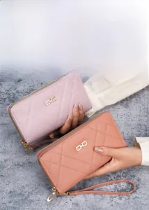 Detail of pink PU leather long wallet with diamond quilting and metal buckle