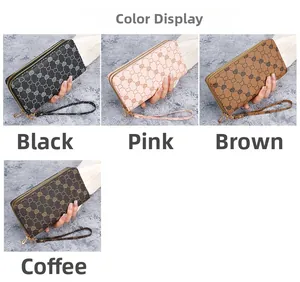 Close-up of four double-zipper long wallets in diverse colors with heart print and wristlet