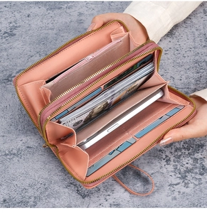 Detailed interior of a pink long double zipper wallet showing card slots and phone pocket