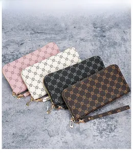 Flat lay of four long zip wallets in pink, white, grey, and coffee with wrist straps
