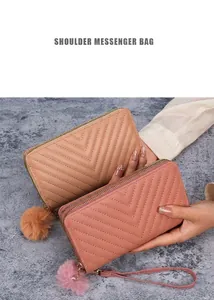 Detail of pink and beige V-quilted long wallets with zippers and pompom charms