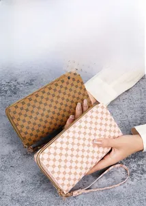Detailed view of long PU leather zip wallets with floral print and wristlet straps