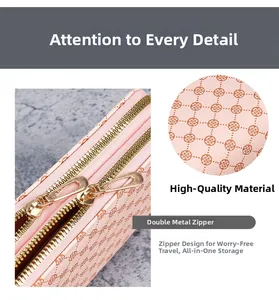 Detail of pink PU leather pouch featuring clover print and dual gold metal zippers