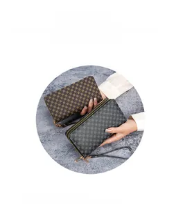 Close-up of double zipper printed wristlet bag in dark coffee and gray synthetic leather