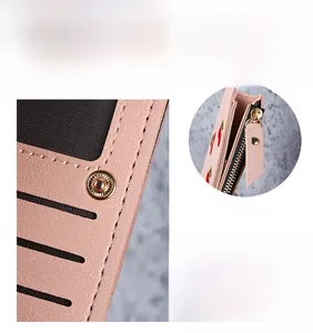 Detail of pink PU leather wallet featuring cherry embroidery and metal snap closure