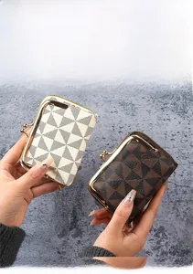 Close-up of geometric pattern card holders with gold metal clasp in beige and brown