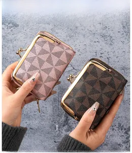Detail of a compact women's wallet showing metallic clasp and geometric pattern