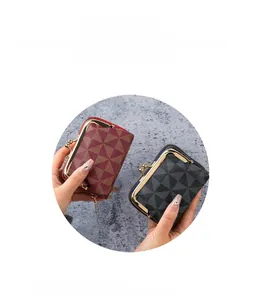 Detail view of vintage mini wallets with geometric patterns and retro clasp closure