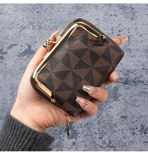 Detail of compact kiss-lock wallet with brown geometric pattern and gold hardware