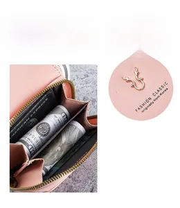 Detail of pink PU leather wallet showing banknote slot, card holders and golden deer buckle