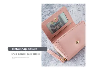 Detail of pink PU leather wallet showing metal snap button closure and photo window slot