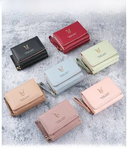 Flat lay of colorful PU leather wallets featuring gold deer head ornaments and textures