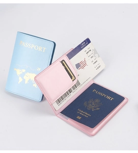 Detail of blue and pink PU leather passport covers with gold map and card slots