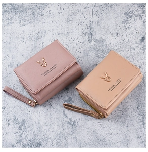 Detail of PU leather wallets featuring antler metal icons and textured lychee pattern